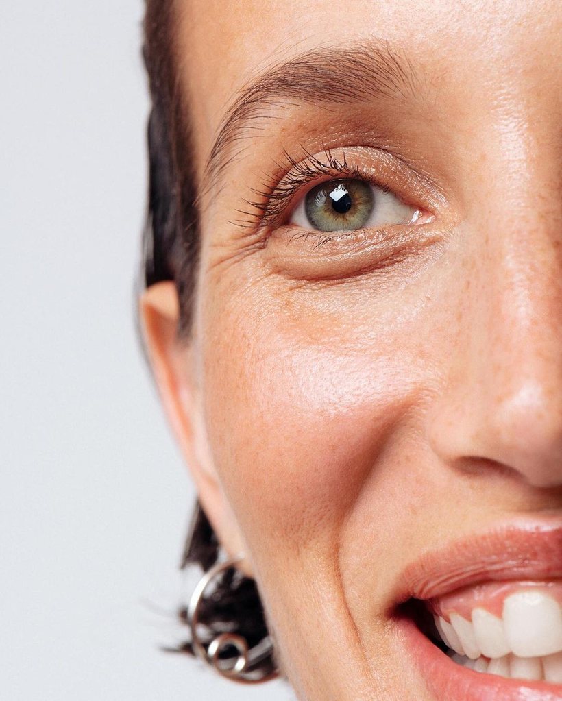 Close-up of a smiling woman with healthy, glowing skin