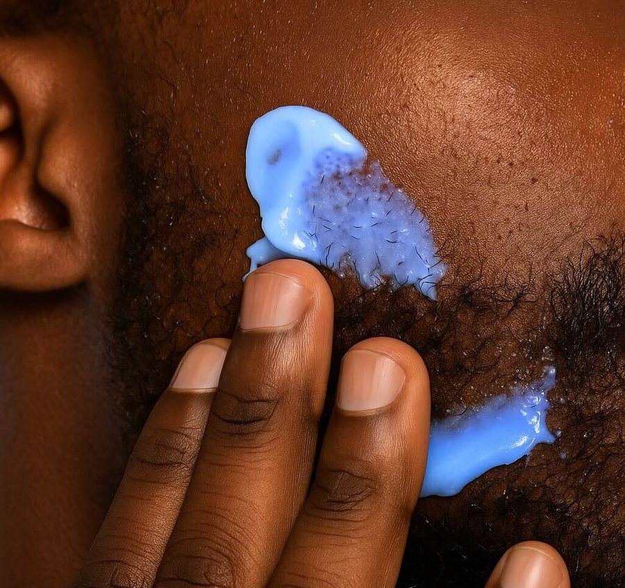 Blue Routine cream applied to deep-toned skin