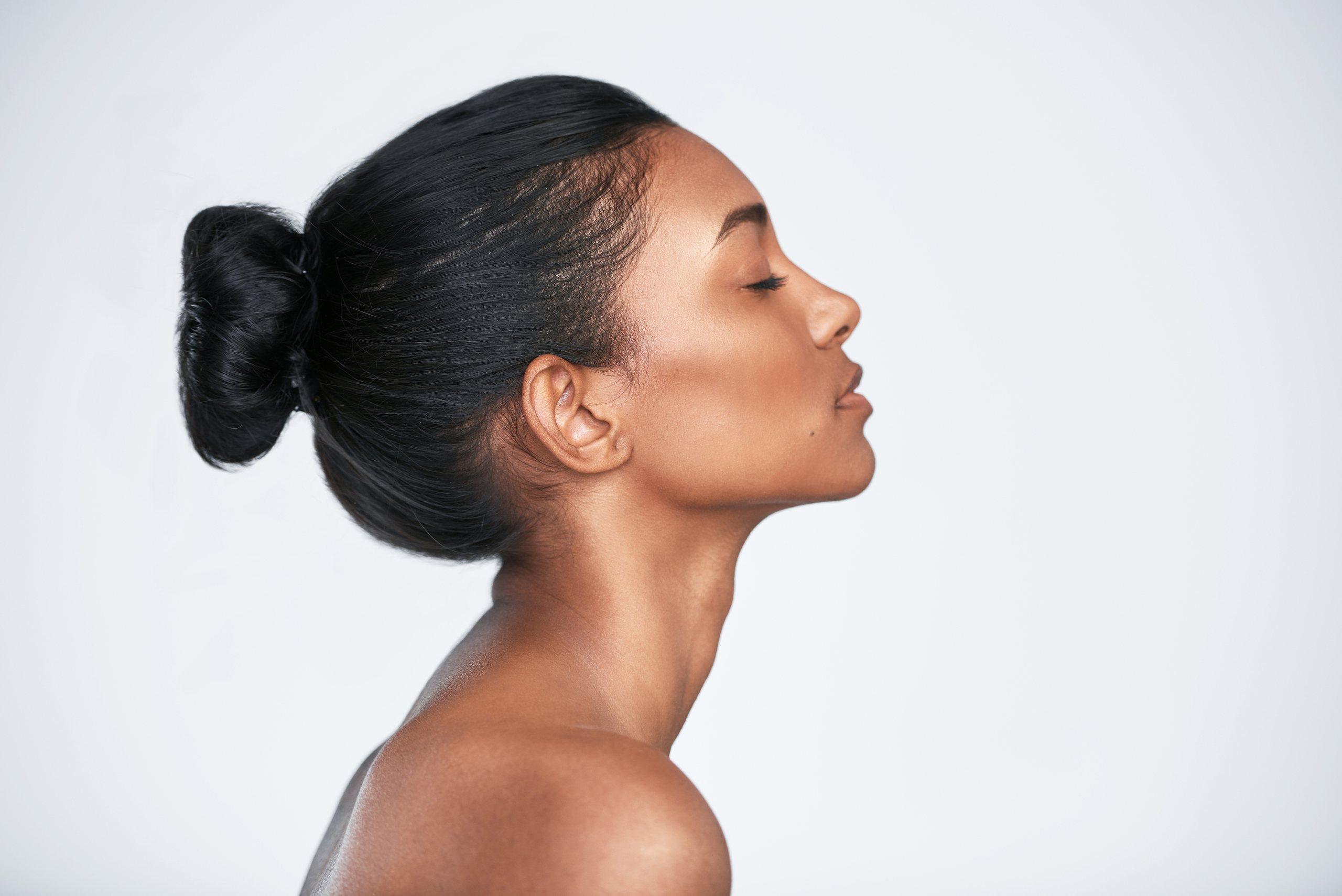 Woman lying back with eyes closed, her skin calm and hydrated